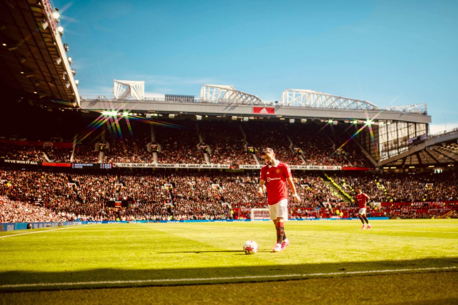 A view of Old Trafford with Manchester United player Bruno Fernandes in the foreground.
