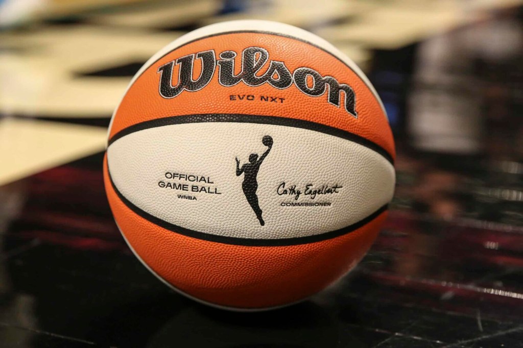 A detail view of a WNBA basketball on the court.