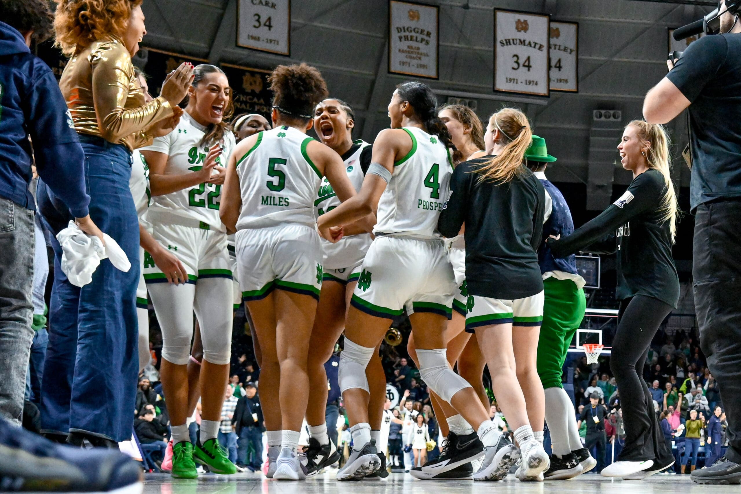 Feb 16, 2023; South Bend, Indiana, USA; The Notre Dame Fighting Irish celebrate after guard Olivia Miles (5) made the game winning basket to defeat the Louisville Cardinals in overtime at the Purcell Pavilion.