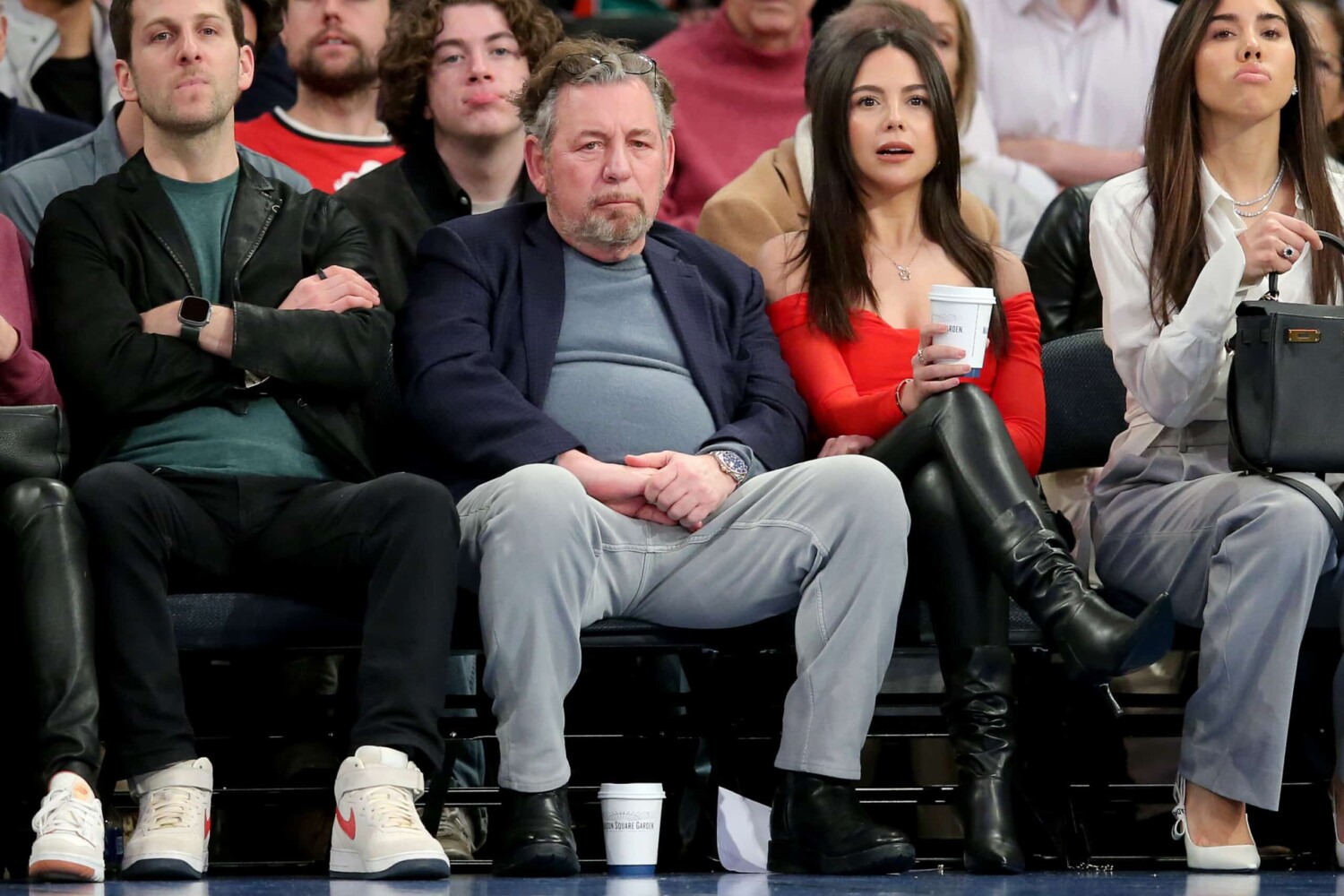 New York Knicks owner James Dolan sitting courtside at a Knicks game at Madison Square Garden.