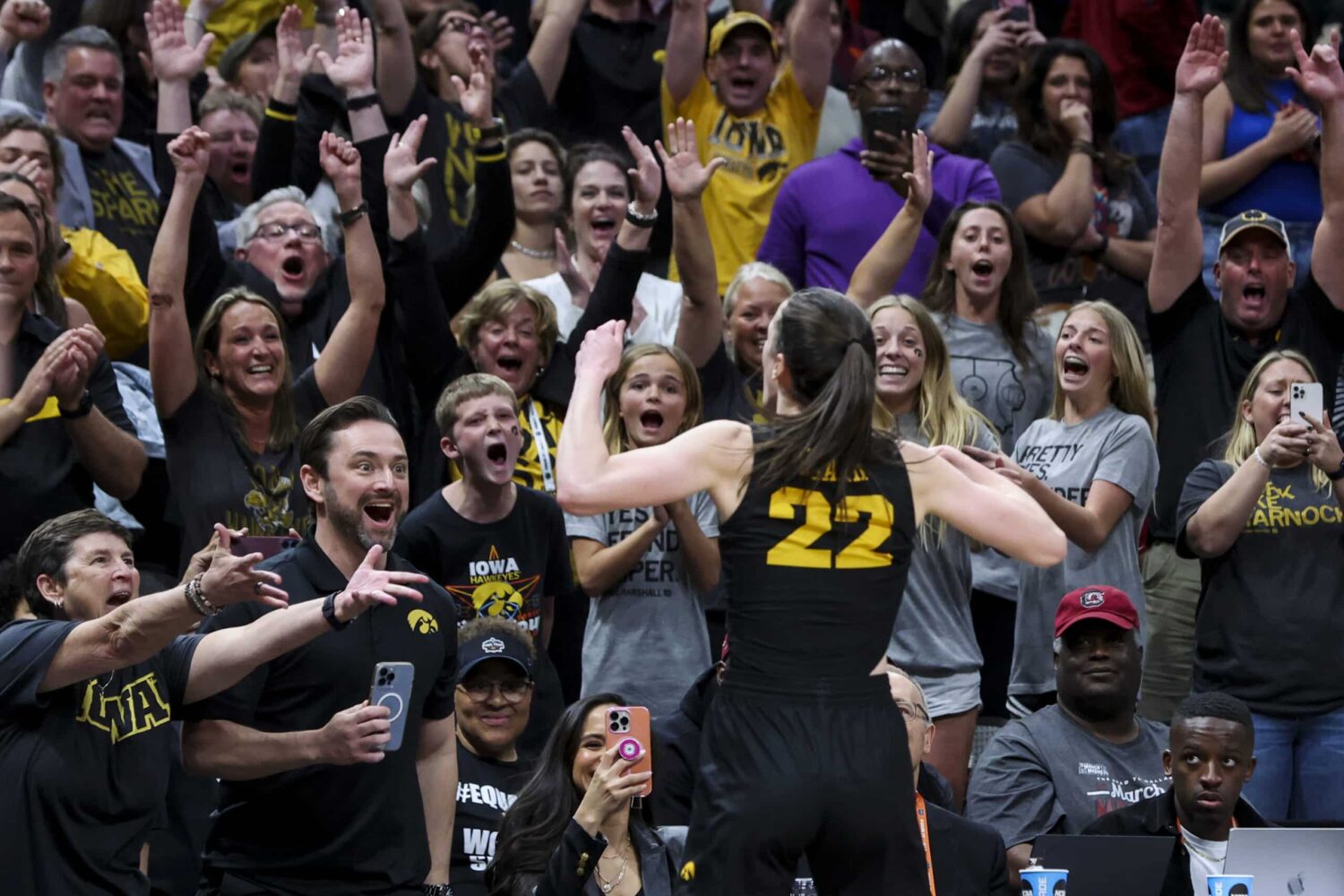 Fans react as Iowa Hawkeyes guard Caitlin Clark celebrates during the women's Final Four.