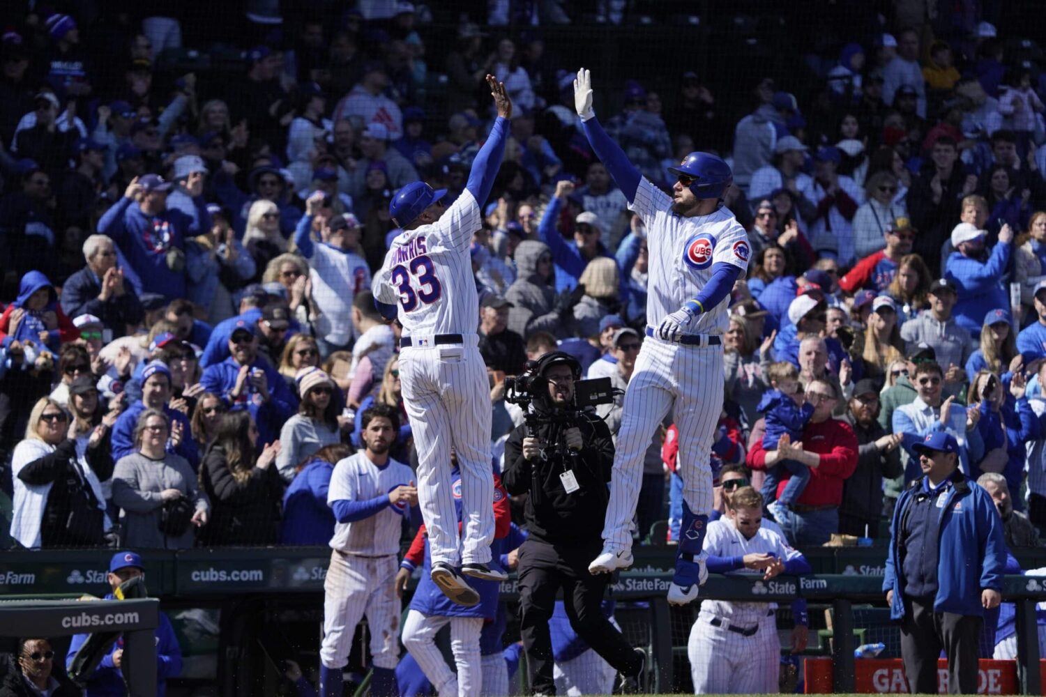 Chicago Cubs right fielder Patrick Wisdom (16) is greeted by Chicago Cubs third base coach Willie Harris (33) after hitting a home run against the Milwaukee Brewers during the second inning at Wrigley Field.