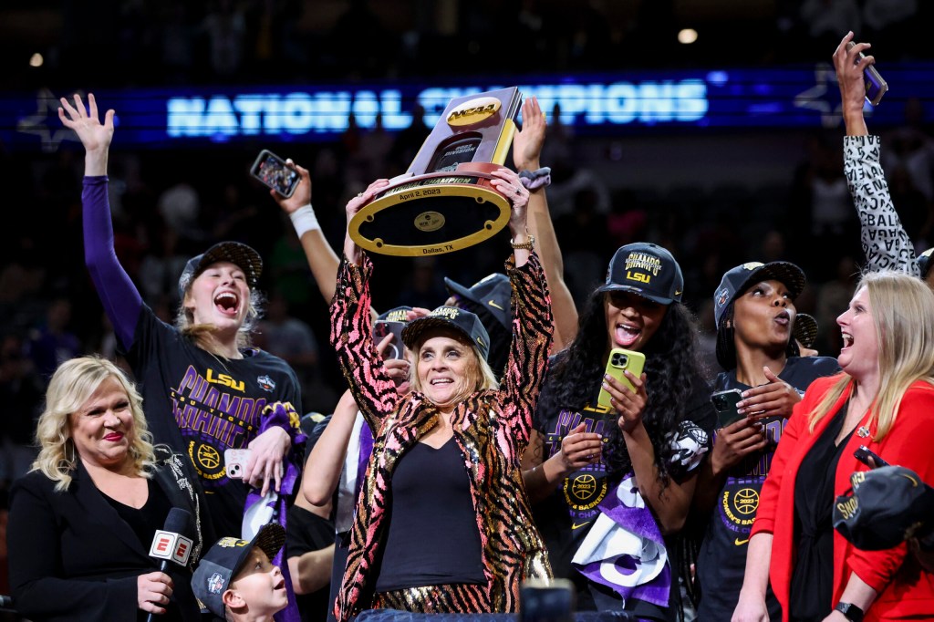 Apr 2, 2023; Dallas, TX, USA; LSU Lady Tigers head coach Kim Mulkey celebrates with the tournament trophy after defeating the Iowa Hawkeyes during the final round of the Women's Final Four NCAA tournament at the American Airlines Center.