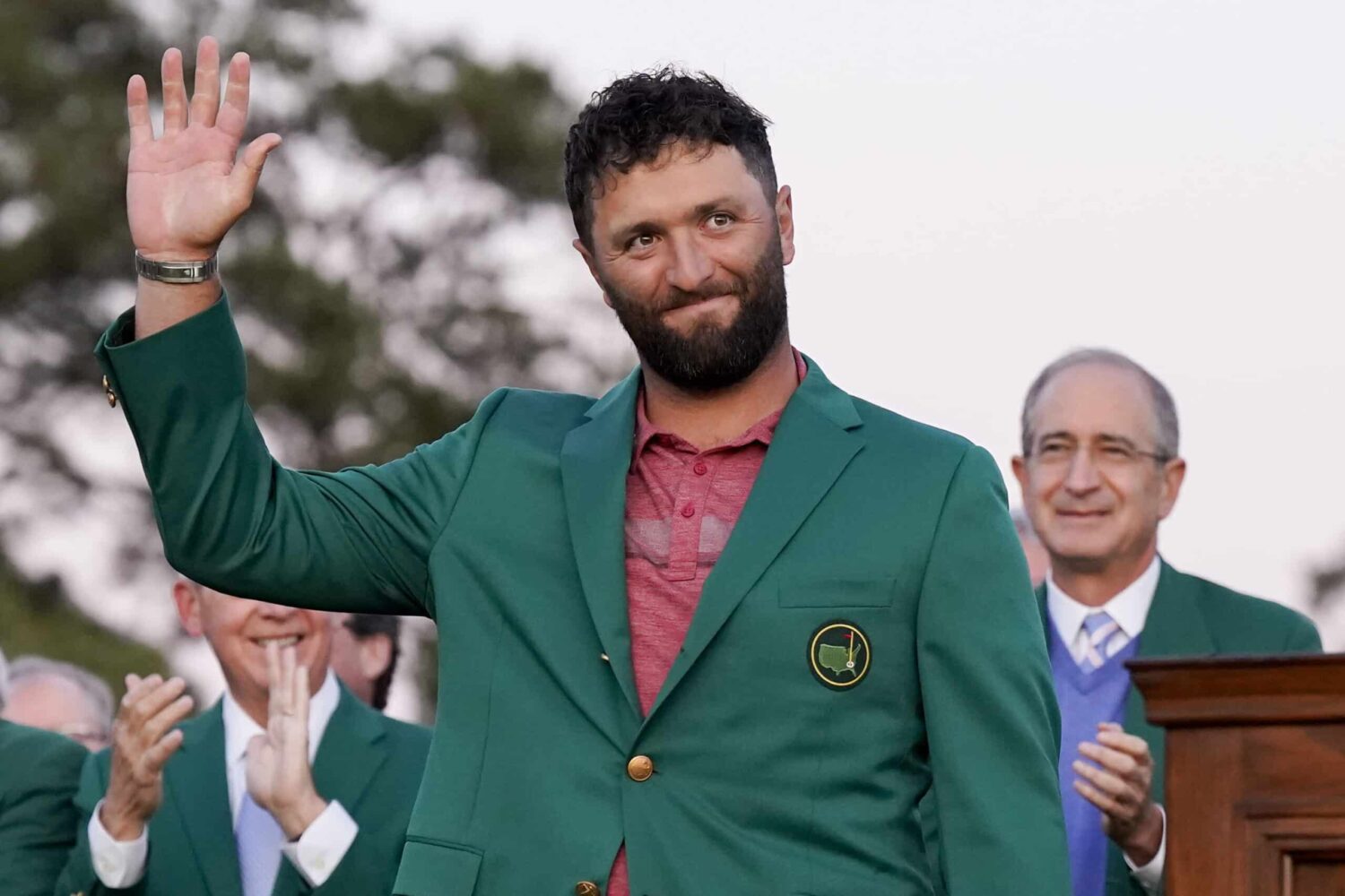 Jon Rahm waves to the crowd after donning his green jacket after winning The Masters golf tournament.