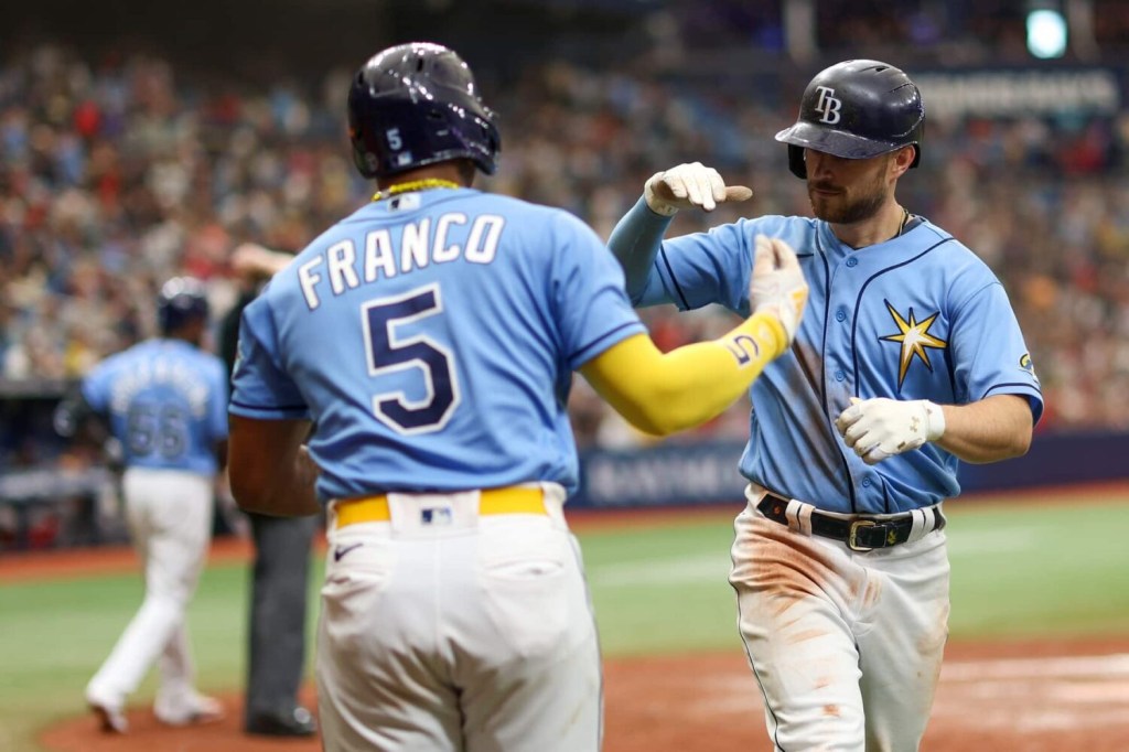 Tampa Bay Rays second baseman Brandon Lowe (8) is congratulated by shortstop Wander Franco (5) after hitting a solo home run against the Boston Red Sox in the seventh inning at Tropicana Field.