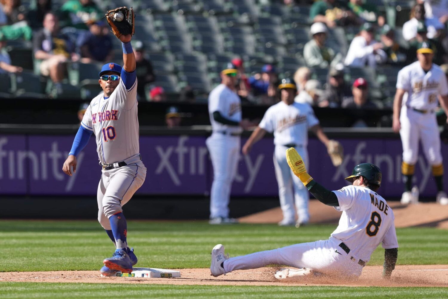 Oakland, California, USA; New York Mets third baseman Eduardo Escobar (10) catches a throw to force out Oakland Athletics pinch hitter Tyler Wade (8) during the tenth inning at RingCentral Coliseum.