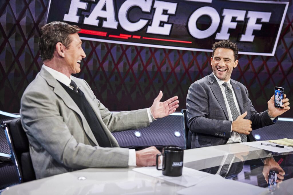 Paul Bissonnette and Wayne Gretzky laughing while at the desk for the NHL on TNT.