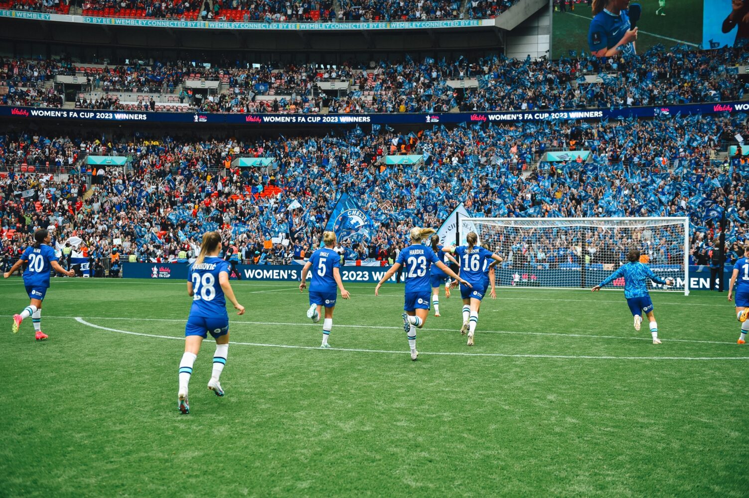 The Chelsea FC Women's team run towards fans in the crowd after winning the 2023 Women's FA Cup.