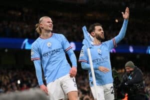 Manchester City players celebrate with the crowd.