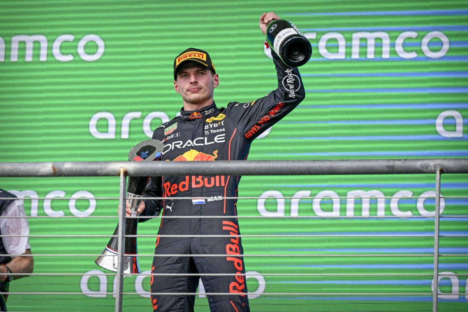 Red Bull Racing's Max Verstappen lifts a champagne bottle and trophy after winning the Formula 1 United States Grand Prix.