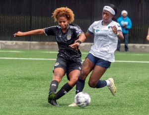 Stockton Cargo's Alexis Brewah, right, fights for the ball with Oakland Soul's Shepherd during the inaugural USL W League game at the San Joaquin Delta College soccer field in Stockton on Saturday, May, 6, 2023.