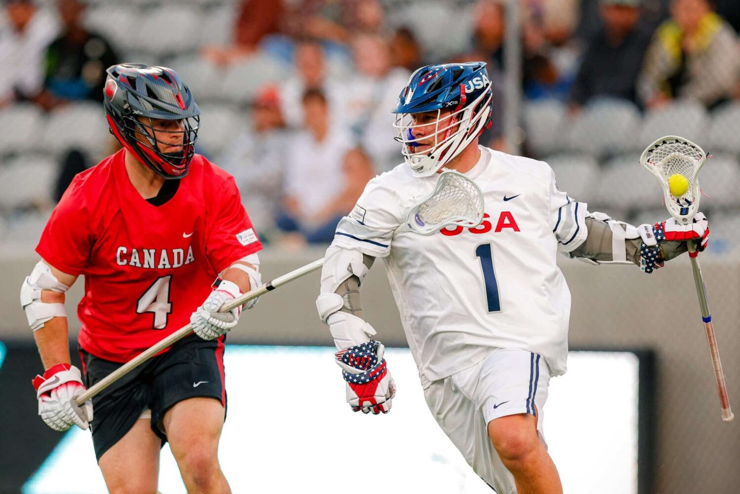 A Canada defender guards a USA player during the World Lacrosse Men's Championship.