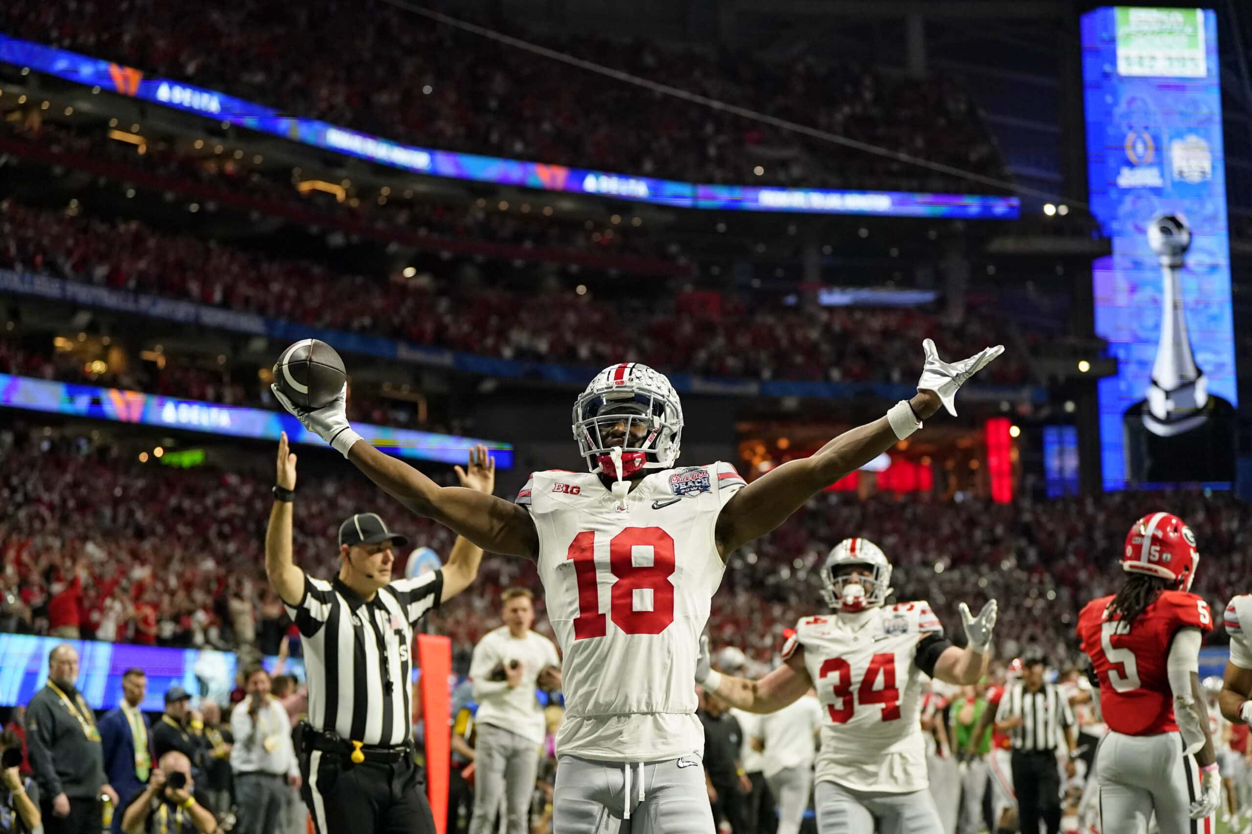 Dec 31, 2022; Atlanta, Georgia, USA; Ohio State Buckeyes wide receiver Marvin Harrison Jr. (18) reacts after scoring a touchdown against the Georgia Bulldogs during the second quarter of the 2022 Peach Bowl at Mercedes-Benz Stadium.