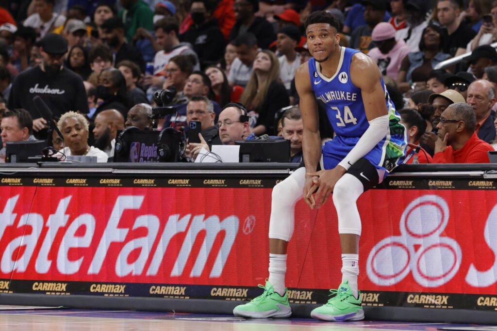 Milwaukee Bucks forward Giannis Antetokounmpo sits on the scorers table during a game against the Washington Wizards.