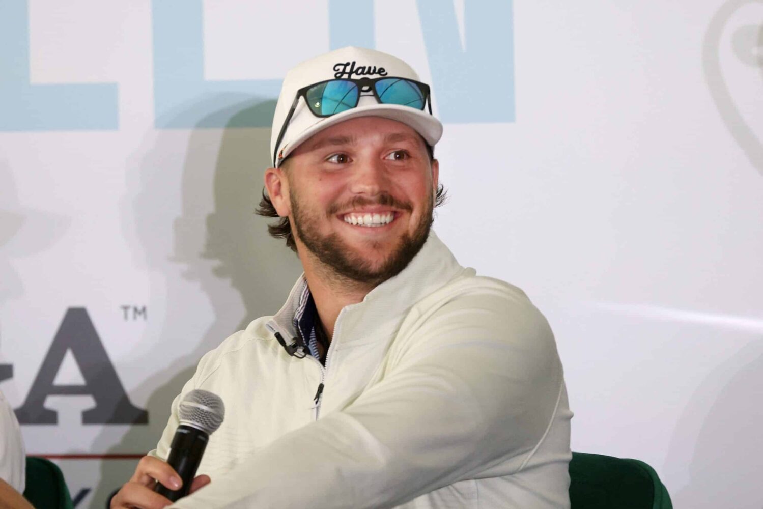 Buffalo Bills quarterback Josh Allen talks into a microphone during a panel discussion.