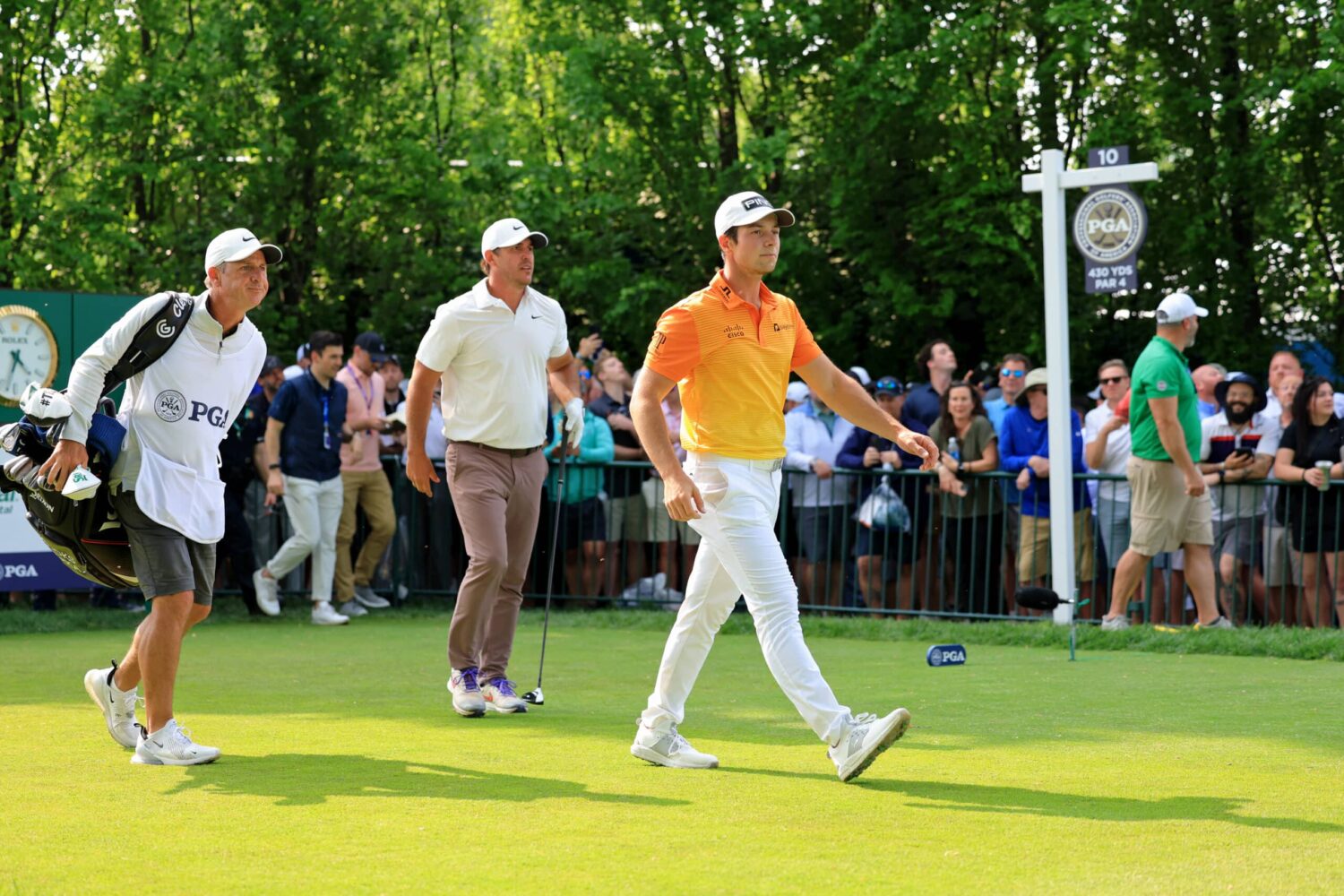 Viktor Hovland and Brooks Koepka walk off the 10th tee during the final round of the PGA Championship golf tournament at Oak Hill Country Club.