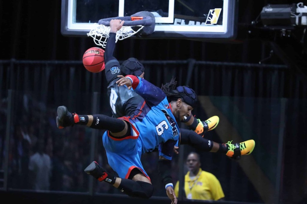 Darion Slade of Wraith dunks over Marcus Gra of Ozone during the third quarter of a SlamBall game at Cox Pavilion in Las Vegas, Nevada.