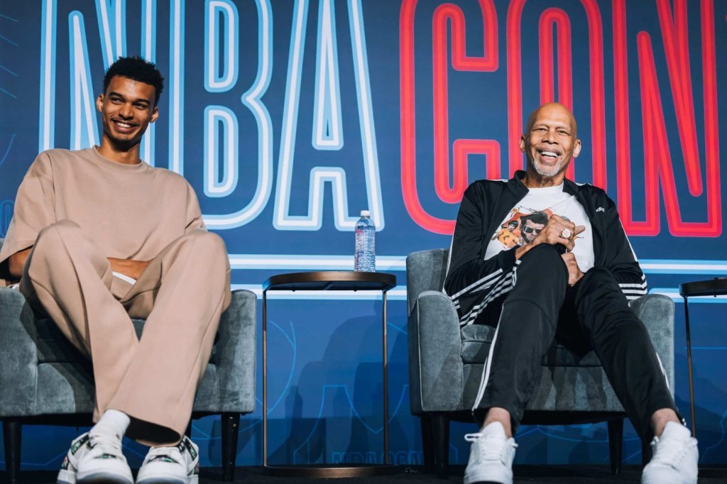 Victor Wembanyama sits next to Kareem Abdul-Jabbar at NBA Con 2023.