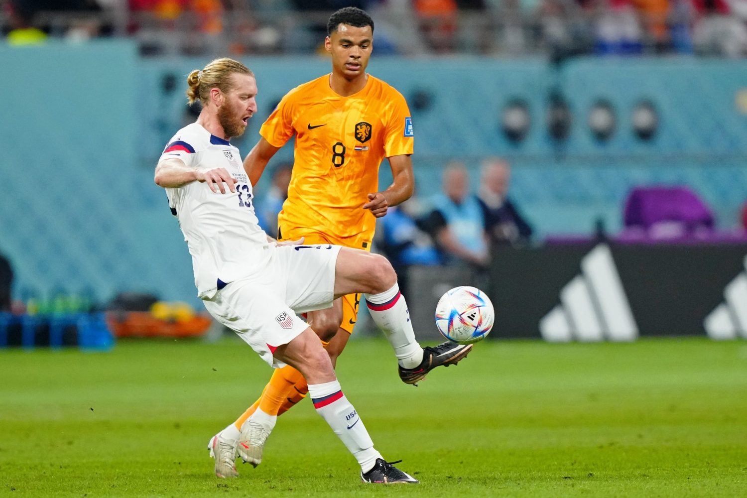 United States of America defender Tim Ream (13) controls the ball against Netherlands forward Cody Gakpo (8) during the first half of a round of sixteen match in the 2022 FIFA World Cup at Khalifa International Stadium.