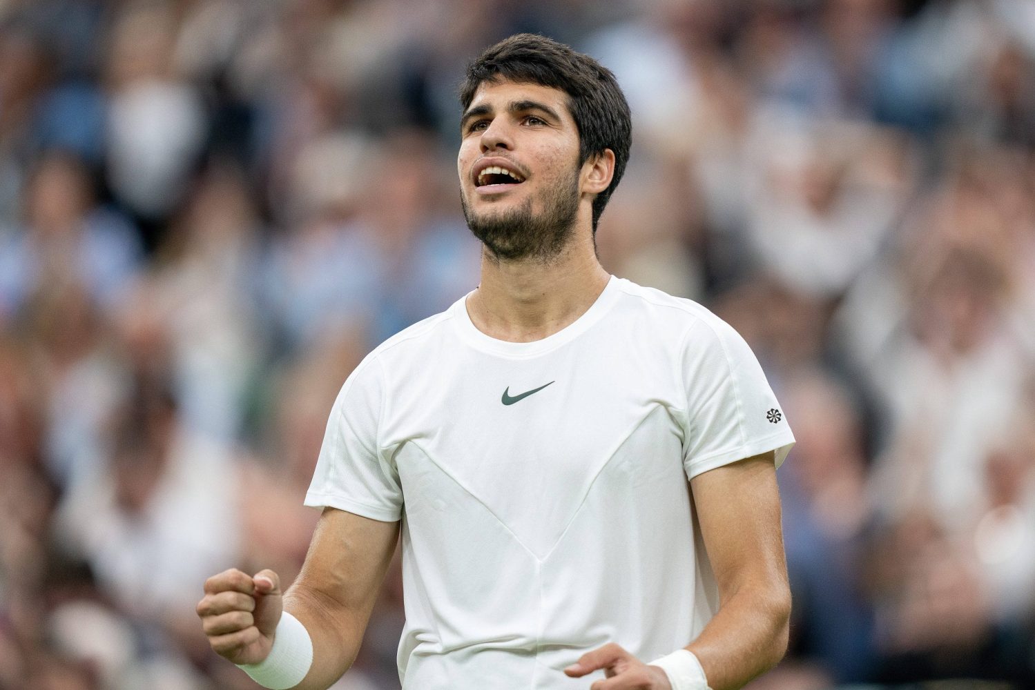 Carlos Alcaraz celebrates winning his match at Wimbledon 2023.