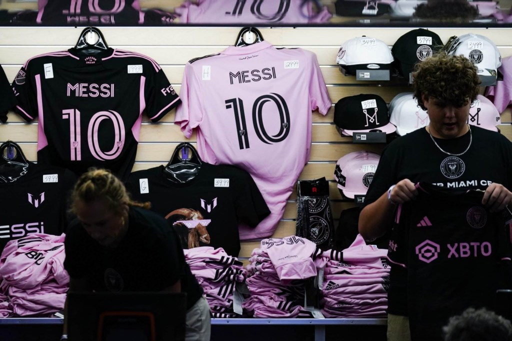 Lionel Messi merchandise seen before the Inter Miami FC forward is introduced at The Unveil event and press conference at DRV PNK Stadium.