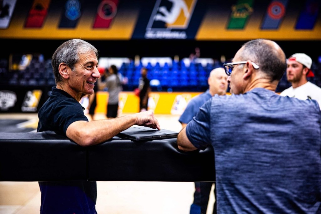 Mike Tollin chats with a colleague during a SlamBall event at Cox Pavilion in Las Vegas, Nevada.