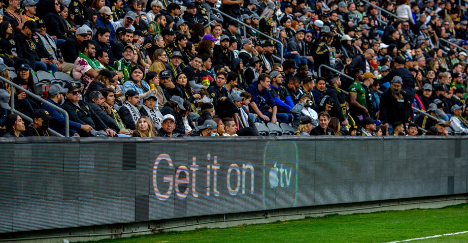 Apple TV advertisement at a football soccer pitch