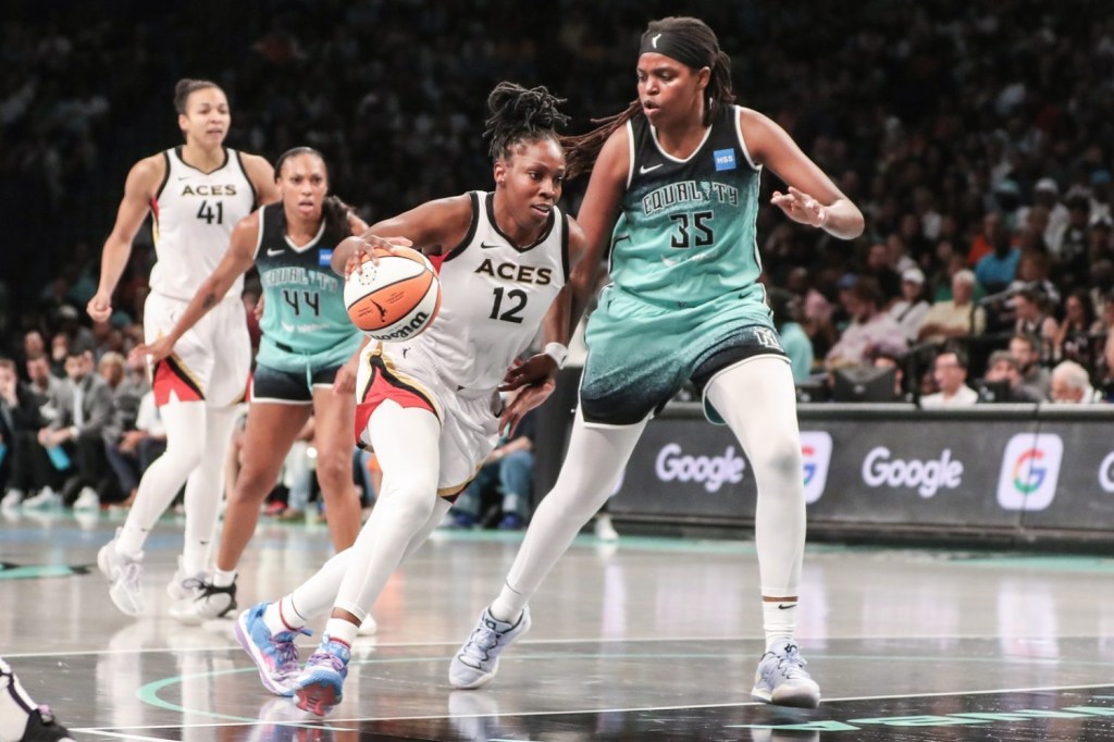 Las Vegas Aces guard Chelsea Gray looks to drive past New York Liberty forward Jonquel Jones during a game at Barclays Center.