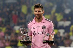 Inter Miami forward Lionel Messi holds two trophies during the trophy ceremony for the Leagues Cup Championship match at GEODIS Park in Nashville.