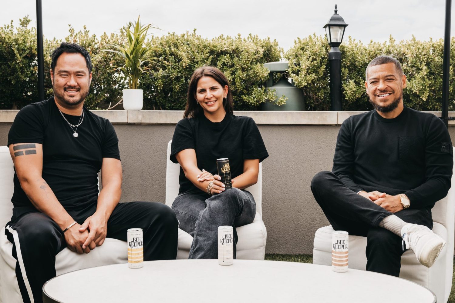 David Creech, Fara Leff, and Paul Rivera pose with cans of their coffee brand Beekeeper Coffee.
