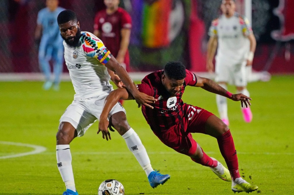 Oakland Roots midfielder Joseph Nane (4) and Phoenix Rising midfielder Carlos Harvey (67) fight for possession during a game on Pride Night at Phoenix Rising Stadium.