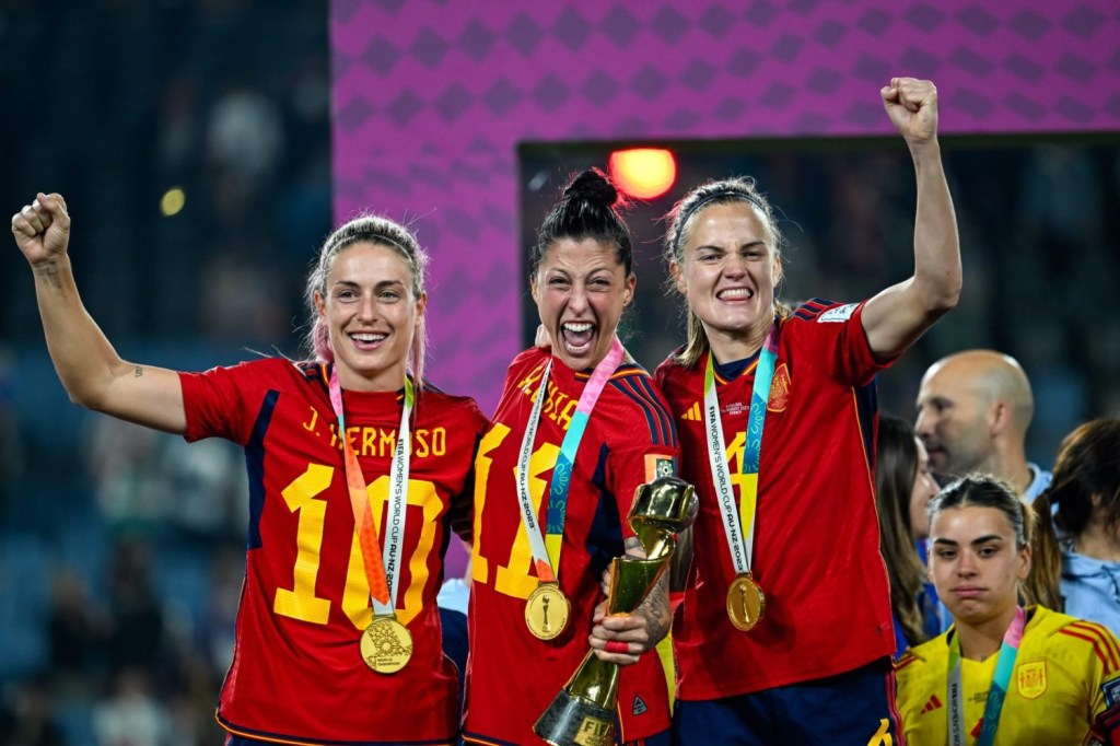 Spain women's national soccer team players celebrate with the World Cup trophy after their victory in the 2023 Women's World Cup.