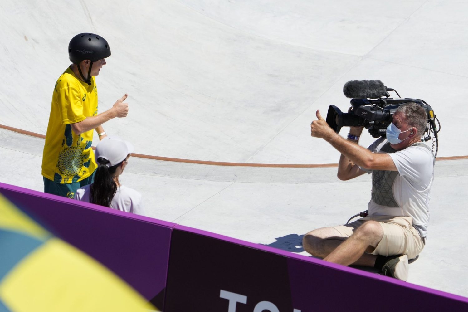 Kieran Woolley checks on a camera man after colliding in the men's skateboarding park prelims during the Tokyo 2020 Olympic Summer Games at Ariake Urban Sports Park.
