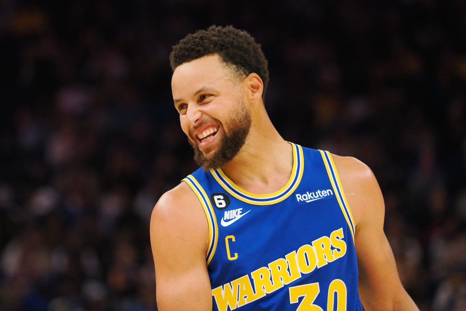 Golden State Warriors point guard Stephen Curry smiles between plays against the San Antonio Spurs during the second quarter at Chase Center.
