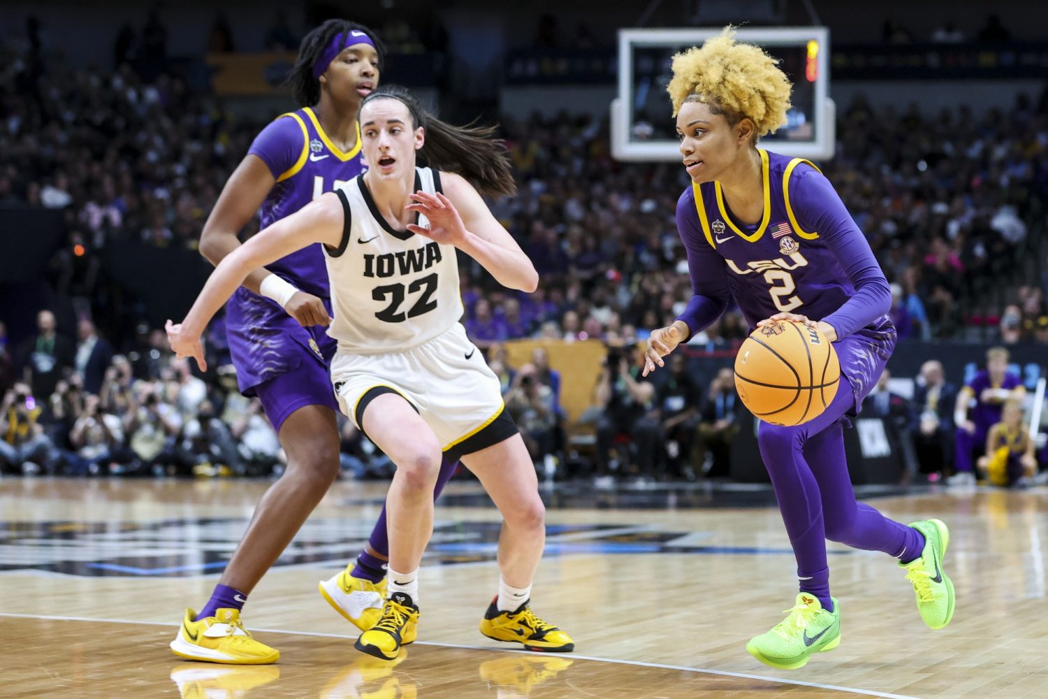 LSU Lady Tigers guard Jasmine Carson dribbles the ball against Iowa Hawkeyes guard Caitlin Clark in the first half during the final round of the Women's Final Four NCAA tournament at the American Airlines Center.