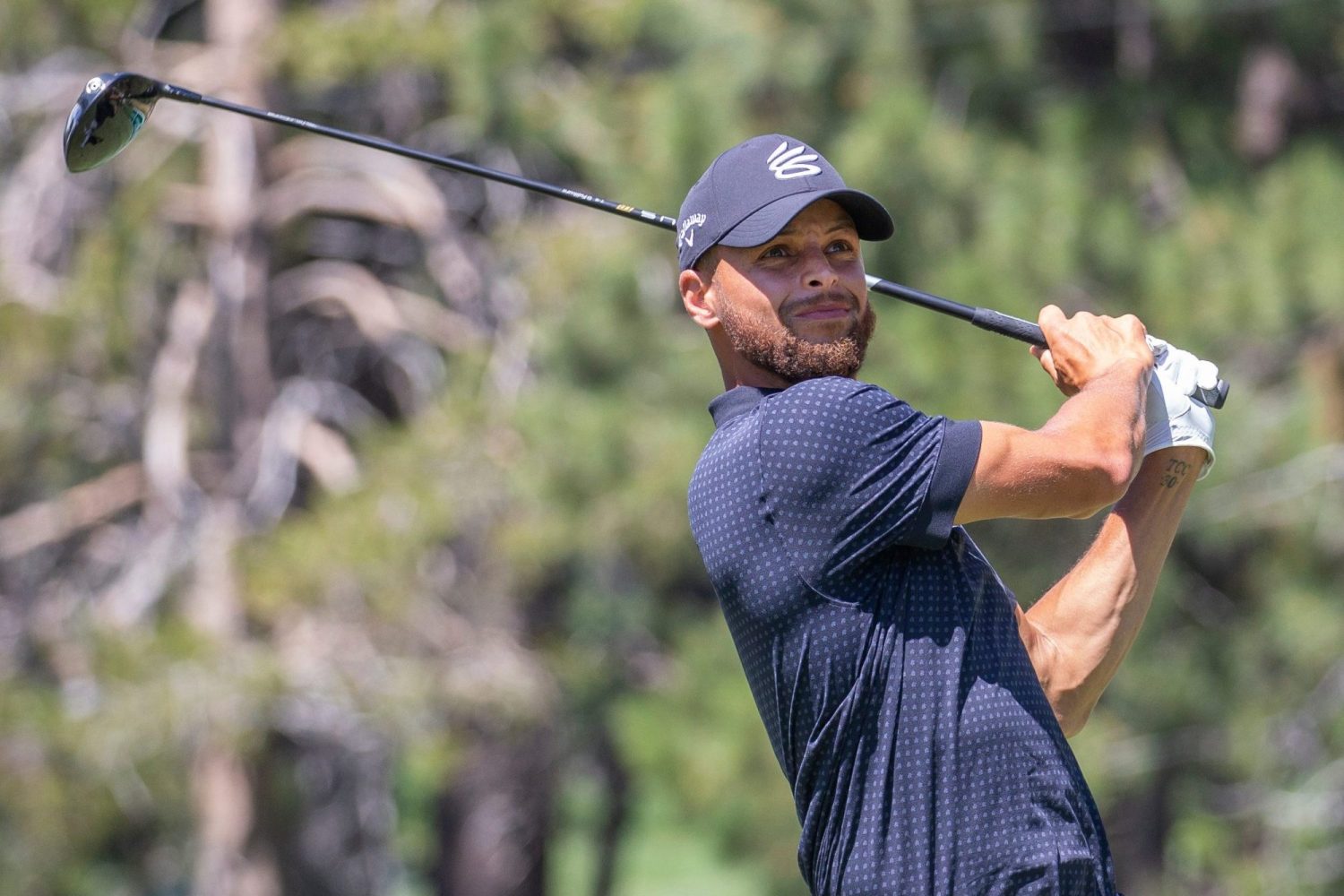 Stephen Curry hits atee shot on the 18th hole during the final round of the American Century Celebrity Championship golf tournament at Edgewood Tahoe Golf Course in Stateline, Nevada.