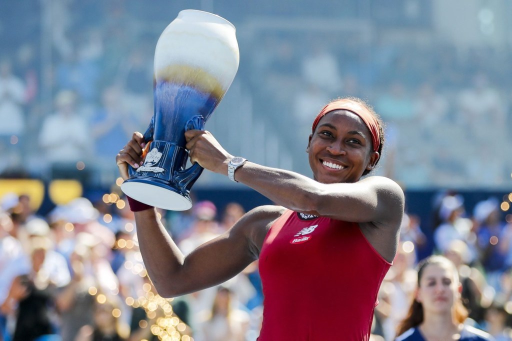 Coco Gauff holds up the Rookwood Cup after the victory over Karolina Muchova during the women’s singles final of the Western and Southern Open tennis tournament at Lindner Family Tennis Center.