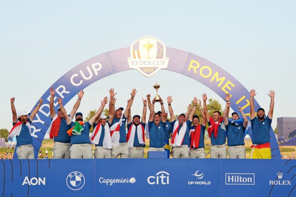 Team Europe captain Luke Donald and Team Europe celebrates with the Ryder Cup after beating Team USA during the final day of the 44th Ryder Cup golf competition at Marco Simone Golf and Country Club.