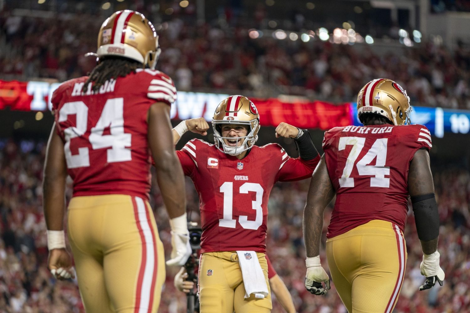 San Francisco 49ers quarterback Brock Purdy celebrates with running back Jordan Mason after a touchdown against the Dallas Cowboys during the fourth quarter at Levi's Stadium.