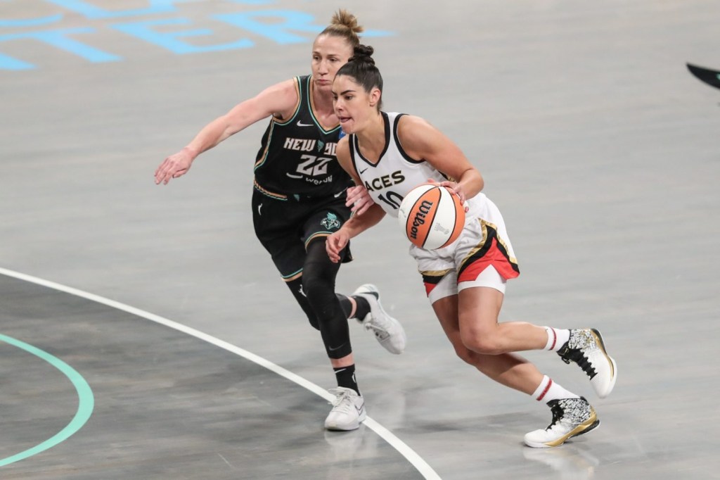 Las Vegas Aces guard Kelsey Plum drives past New York Liberty guard Courtney Vandersloot in the first quarter during game four of the 2023 WNBA Finals at Barclays Center.