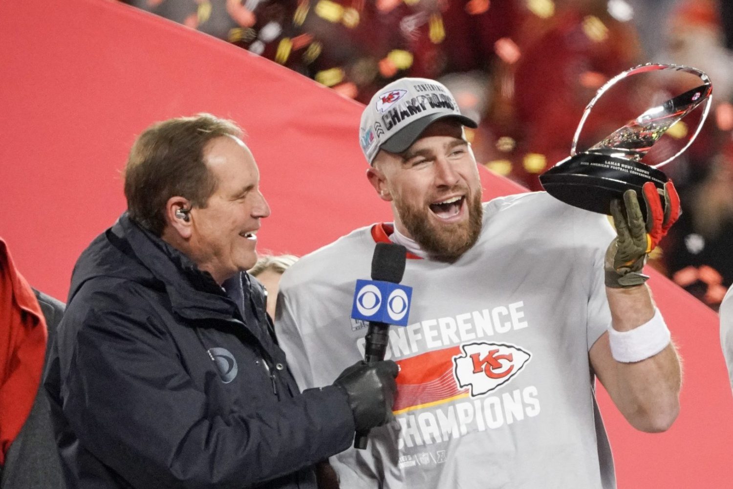 Kansas City Chiefs tight end Travis Kelce talks with CBS announcer Jim Nantz after winning the AFC Championship game against the Cincinnati Bengals at GEHA Field at Arrowhead Stadium.