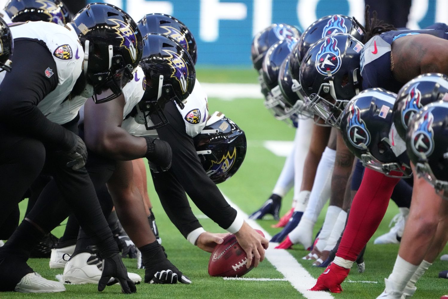 A general overall view of the line of helmets at the line of scrimmage as Baltimore Ravens long snapper Tyler Ott snaps the ball against the Tennessee Titans in the first half during an NFL International Series game at Tottenham Hotspur Stadium.