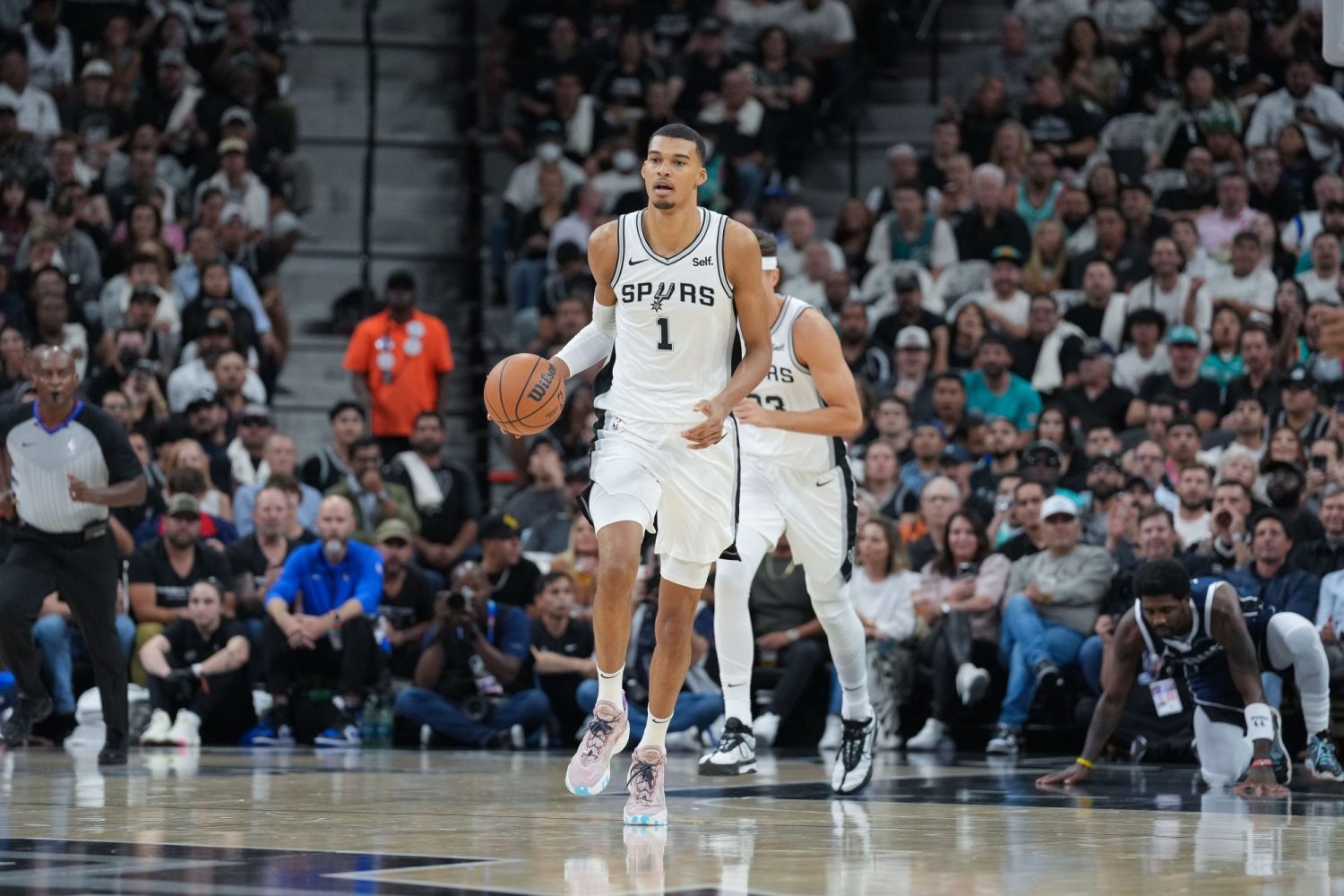 San Antonio Spurs center Victor Wembanyama dribbles up the court in the first half against the Dallas Mavericks at the Frost Bank Center.