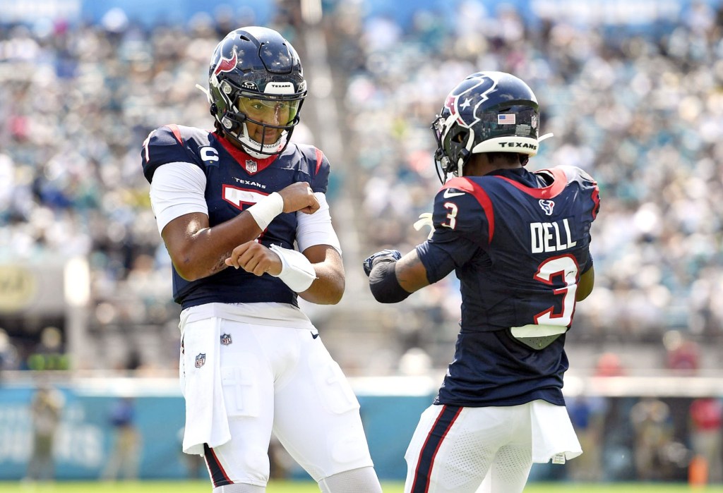 Sep 24, 2023; Jacksonville, Florida, USA; Houston Texans quarterback CJ Stroud (7) celebrates a touchdown with wide receiver Tank Dell (3) during the first half against the Jacksonville Jaguars at EverBank Stadium.