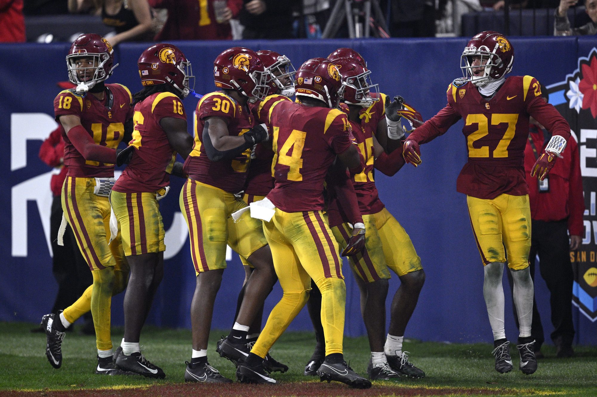 Dec 27, 2023; San Diego, CA, USA; USC Trojans players celebrate after a turnover against the Louisville Cardinals during the second half at Petco Park.