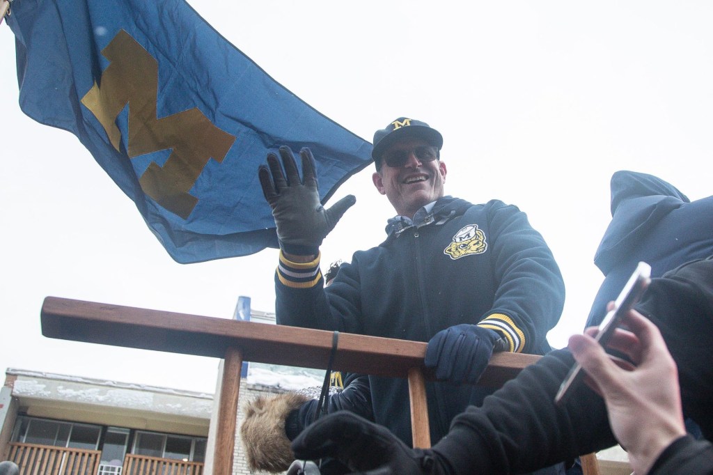 Michigan head coach Jim Harbaugh waves at fans during the National Championship parade in Ann Arbor on Saturday, Jan. 13, 2024.