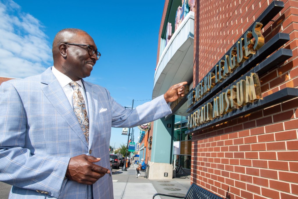 Oct 5, 2021; Kansas City, Missouri, USA; Bob Kendrick, president of the Negro Leagues Baseball Museum in Kansas City, points to the lettering outside of the museum Tuesday.