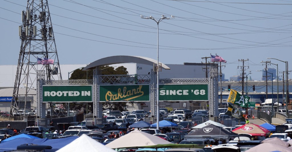 Aug 5, 2023; Oakland, California, USA; Oakland Athletics signage appears above the entrance to the parking lot as fans tailgate under tents before the game against the San Francisco Giants at Oakland-Alameda County Coliseum.