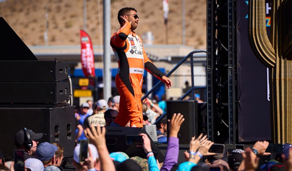 NASCAR Cup Series driver Bubba Wallace (23), in a Star Wars rebel alliance X-wing fighter pilot-inspired race suit, motions to the crowd to get louder during the driver introductions for the Cup Series Championship race at Phoenix Raceway in Avondale on Nov. 5, 2023.