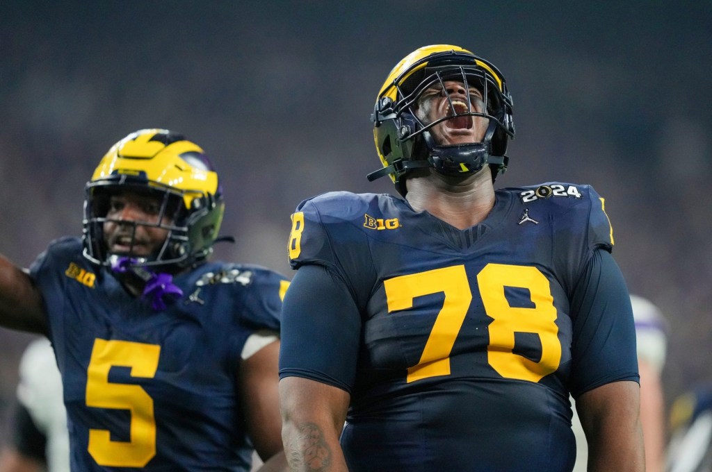 Michigan defensive lineman Kenneth Grant celebrates a sack on Washington quarterback Michael Penix Jr. in the second quarter during the College Football Playoff national championship game against Washington at NRG Stadium in Houston, Texas on Monday, Jan. 8, 2024.